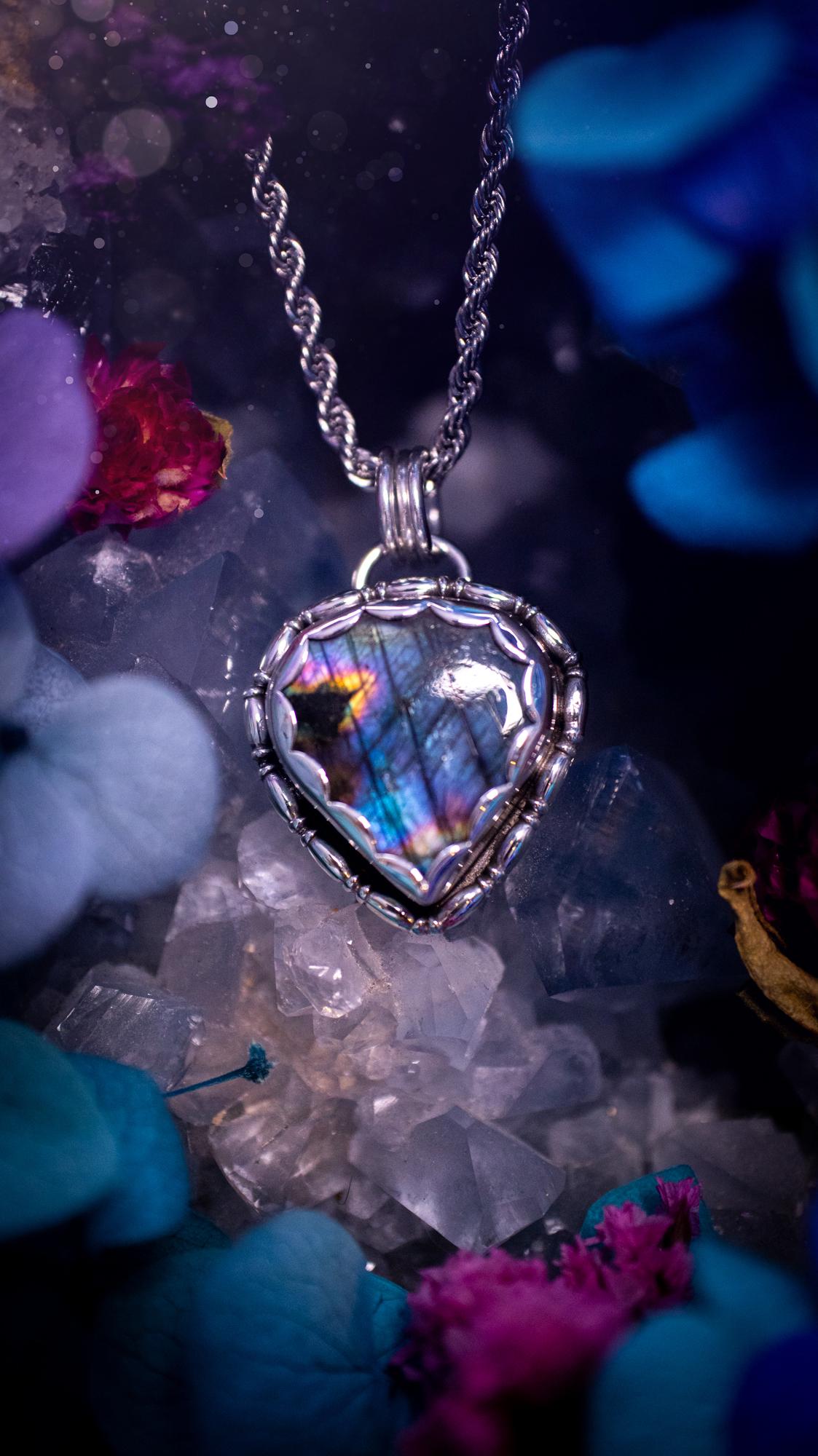 Beautifully handcrafted, rainbow labradorite crystal pendant necklace. This beautiful pendant has been crafted out of sterling and fine silver and features gothic bezel wire around the labradorite crystal in a scallop bezel. The labradorite in this piece is full of beautiful colours, purple, pinks and colours of the rainbow! This jewellery piece would be ideal for anyone who is a fan of jewellery and crystals, and would make the ideal gift. Full of witchy and gothic vibes!