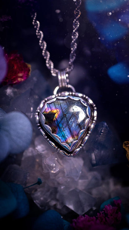 Beautifully handcrafted, rainbow labradorite crystal pendant necklace. This beautiful pendant has been crafted out of sterling and fine silver and features gothic bezel wire around the labradorite crystal in a scallop bezel. The labradorite in this piece is full of beautiful colours, purple, pinks and colours of the rainbow! This jewellery piece would be ideal for anyone who is a fan of jewellery and crystals, and would make the ideal gift. Full of witchy and gothic vibes!