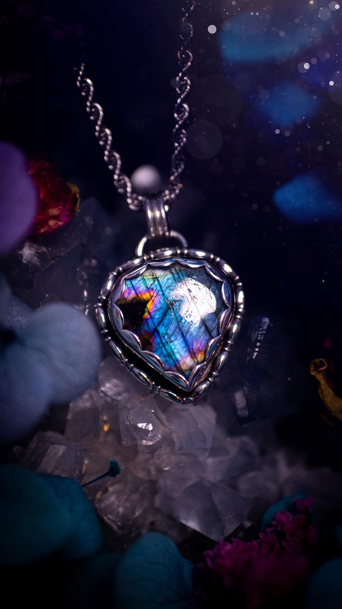 Beautifully handcrafted, rainbow labradorite crystal pendant necklace. This beautiful pendant has been crafted out of sterling and fine silver and features gothic bezel wire around the labradorite crystal in a scallop bezel. The labradorite in this piece is full of beautiful colours, purple, pinks and colours of the rainbow! This jewellery piece would be ideal for anyone who is a fan of jewellery and crystals, and would make the ideal gift. Full of witchy and gothic vibes!