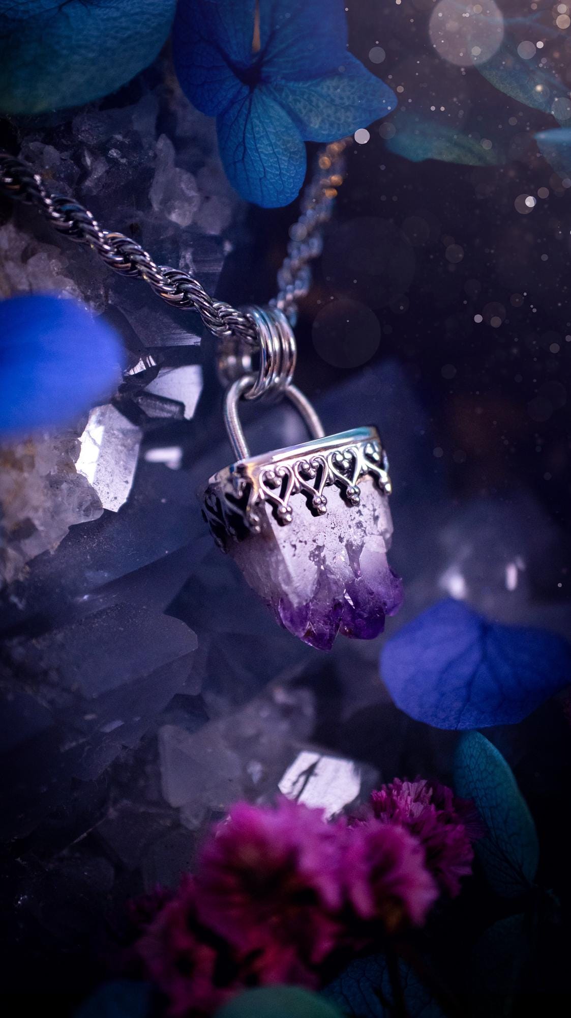 Handmade and beautiful, natural amethyst crystal cluster pendant necklace. This lovely piece of jewellery is made from a mix of fine and sterling silver. It features a beautiful mini amethyst crystal cluster that has lots of formations and rainbows within the inclusions! Full of sparkle with a lovely deep purple hue at the points. This piece of jewellery would be ideal for any crystal and jewellery lover, or even for birthdays as amethyst is the birthstone for February. Gothic and witchy