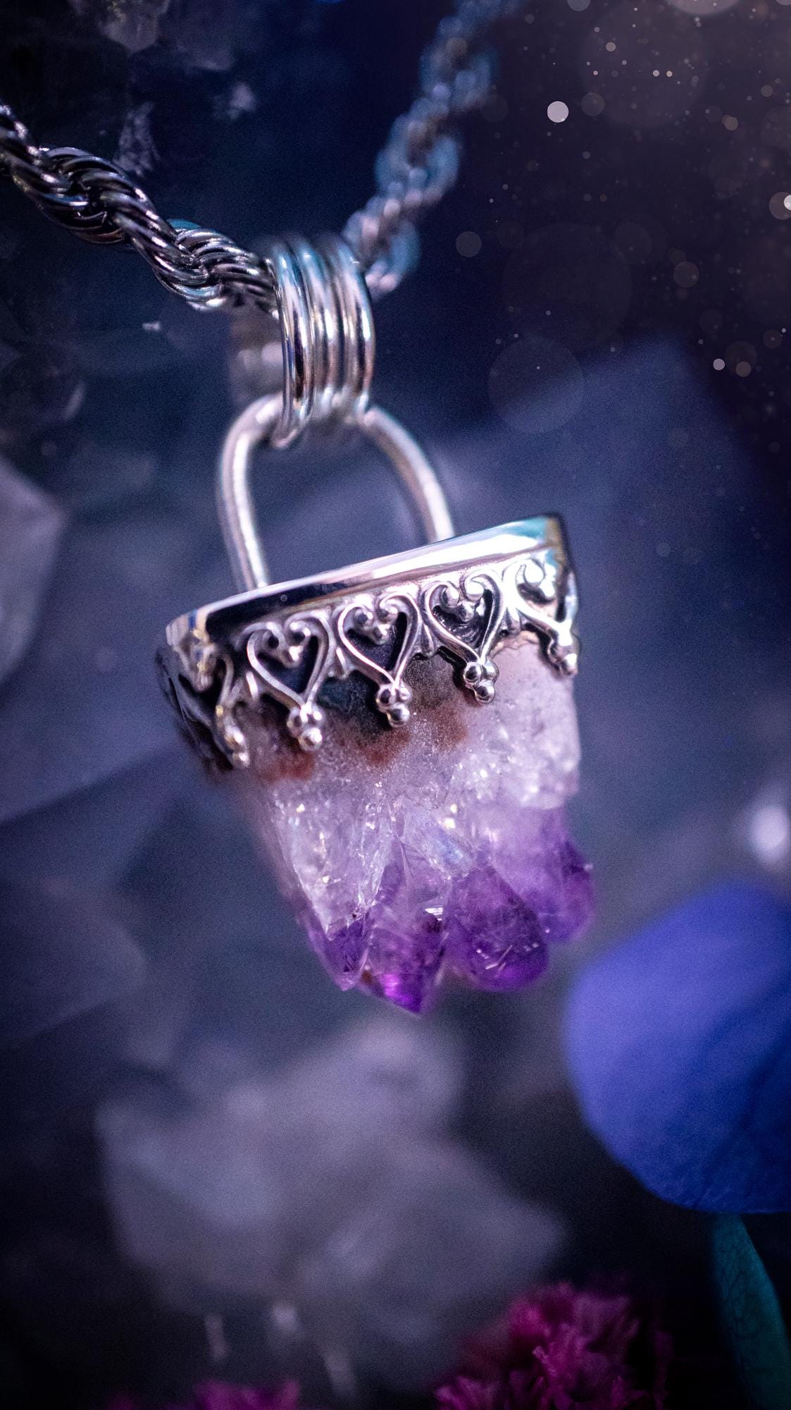 Handmade and beautiful, natural amethyst crystal cluster pendant necklace. This lovely piece of jewellery is made from a mix of fine and sterling silver. It features a beautiful mini amethyst crystal cluster that has lots of formations and rainbows within the inclusions! Full of sparkle with a lovely deep purple hue at the points. This piece of jewellery would be ideal for any crystal and jewellery lover, or even for birthdays as amethyst is the birthstone for February. Gothic and witchy