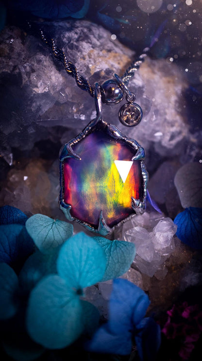 A beautiful, one of a kind, aurora opal pendant necklace. This little statement necklace is handmade using the tiffany technique, also known as soft soldering. Featuring the most stunning, and sparkly aurora opal which is full of pinks, greens and blues just like the northern lights. Aurora opals are man made opals that look similar to natural ones, they have a layer of rose quartz on top to give extra shine. The ideal gift for any crystal or jewellery lover. Gothic and witchy jewellery