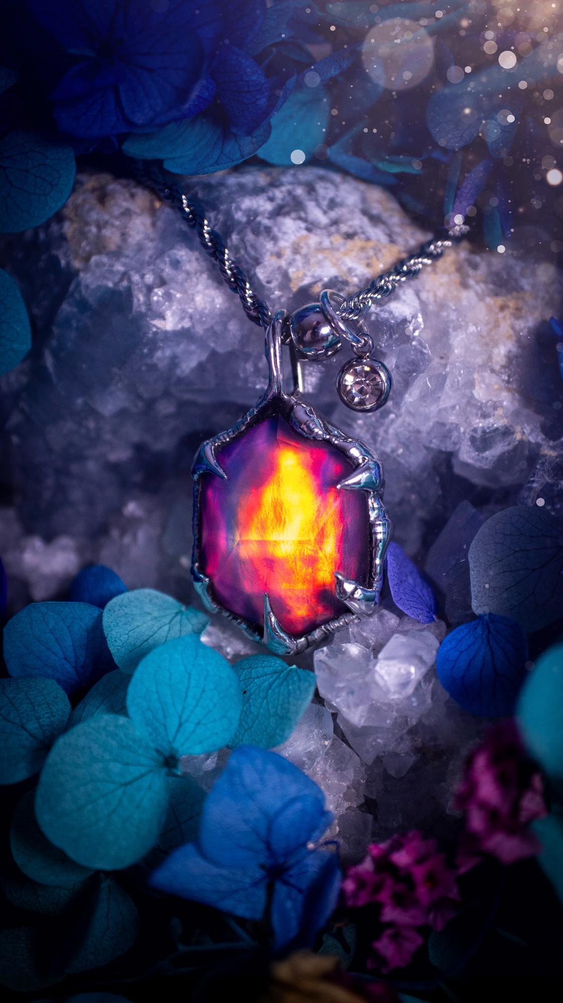 A beautiful, one of a kind, aurora opal pendant necklace. This little statement necklace is handmade using the tiffany technique, also known as soft soldering. Featuring the most stunning, and sparkly aurora opal which is full of pinks, greens and blues just like the northern lights. Aurora opals are man made opals that look similar to natural ones, they have a layer of rose quartz on top to give extra shine. The ideal gift for any crystal or jewellery lover. Gothic and witchy jewellery