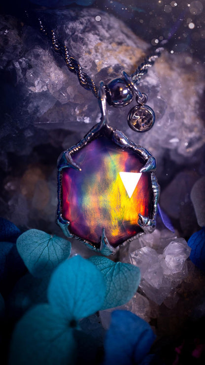 A beautiful, one of a kind, aurora opal pendant necklace. This little statement necklace is handmade using the tiffany technique, also known as soft soldering. Featuring the most stunning, and sparkly aurora opal which is full of pinks, greens and blues just like the northern lights. Aurora opals are man made opals that look similar to natural ones, they have a layer of rose quartz on top to give extra shine. The ideal gift for any crystal or jewellery lover. Gothic and witchy jewellery