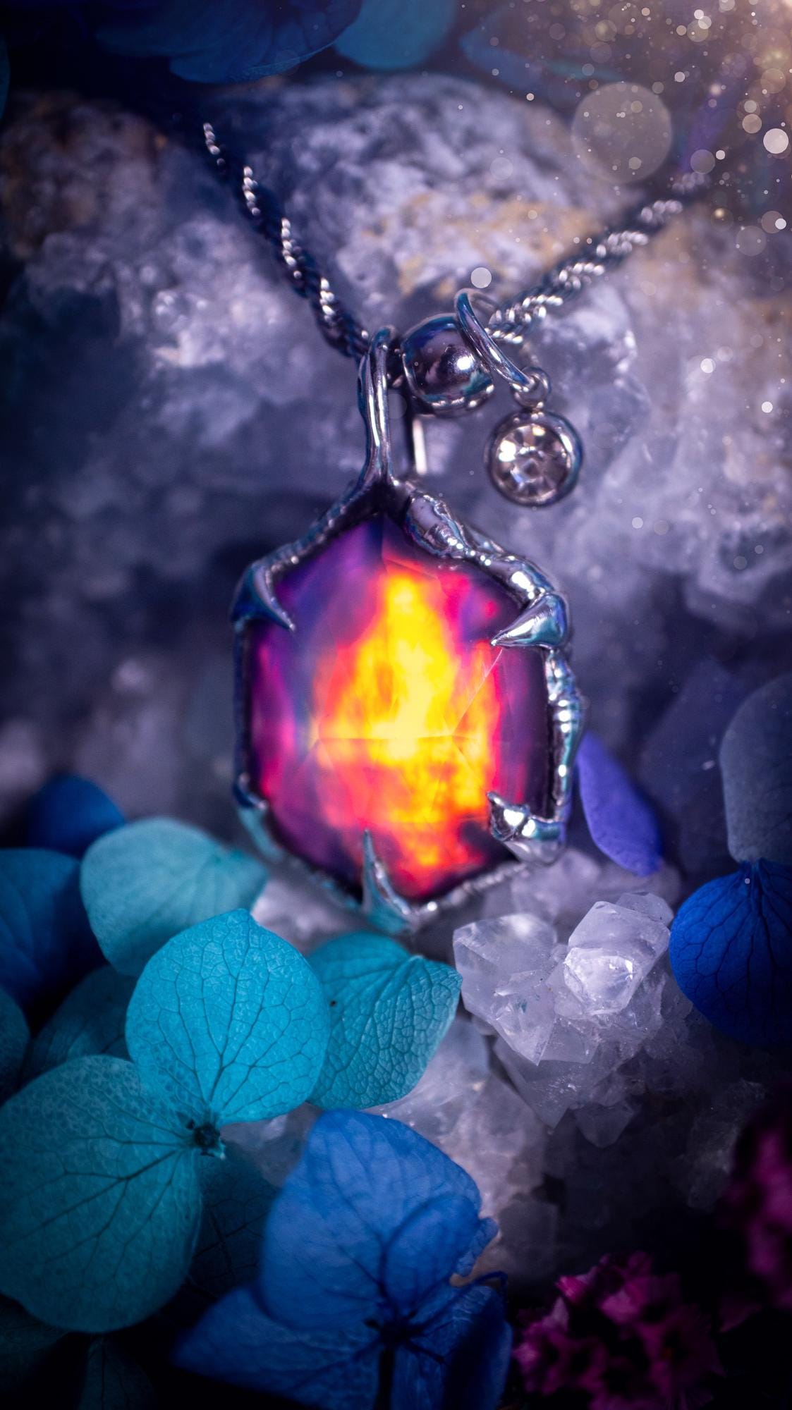 A beautiful, one of a kind, aurora opal pendant necklace. This little statement necklace is handmade using the tiffany technique, also known as soft soldering. Featuring the most stunning, and sparkly aurora opal which is full of pinks, greens and blues just like the northern lights. Aurora opals are man made opals that look similar to natural ones, they have a layer of rose quartz on top to give extra shine. The ideal gift for any crystal or jewellery lover. Gothic and witchy jewellery