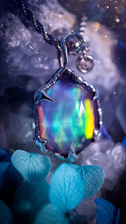 A beautiful, one of a kind, aurora opal pendant necklace. This little statement necklace is handmade using the tiffany technique, also known as soft soldering. Featuring the most stunning, and sparkly aurora opal which is full of pinks, greens and blues just like the northern lights. Aurora opals are man made opals that look similar to natural ones, they have a layer of rose quartz on top to give extra shine. The ideal gift for any crystal or jewellery lover. Gothic and witchy jewellery