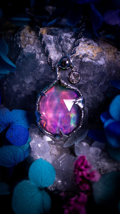 A beautiful, one of a kind, aurora opal pendant necklace. This little statement necklace is handmade using the tiffany technique, also known as soft soldering. Featuring the most stunning, and sparkly aurora opal which is full of pinks, greens and blues just like the northern lights. Aurora opals are man made opals that look similar to natural ones, they have a layer of rose quartz on top to give extra shine. The ideal gift for any crystal or jewellery lover. Gothic and witchy jewellery