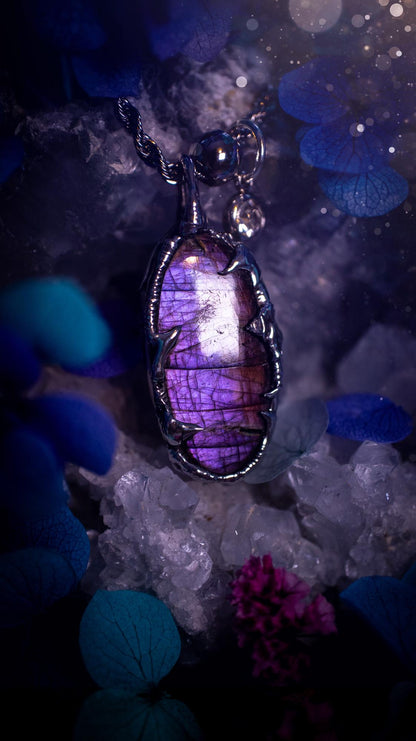 Beautifully handmade and bespoke, purple labradorite, soft soldered pendant necklace. This dainty labradorite pendant has been crafted using the soft solder method, also known as the tiffany technique. The crystal has a bezel of lead free soft solder which contains small parts of silver that allows for oxidisation and a high lustre polish. This labradorite is full of beautiful pinks, purples and has a lovely flash. One off, gothic and witchy jewellery with little claws on the bezel.
