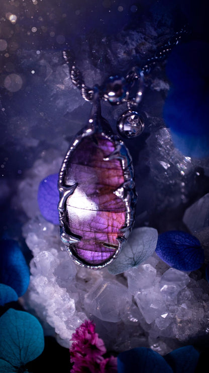 Beautifully handmade and bespoke, purple labradorite, soft soldered pendant necklace. This dainty labradorite pendant has been crafted using the soft solder method, also known as the tiffany technique. The crystal has a bezel of lead free soft solder which contains small parts of silver that allows for oxidisation and a high lustre polish. This labradorite is full of beautiful pinks, purples and has a lovely flash. One off, gothic and witchy jewellery with little claws on the bezel.