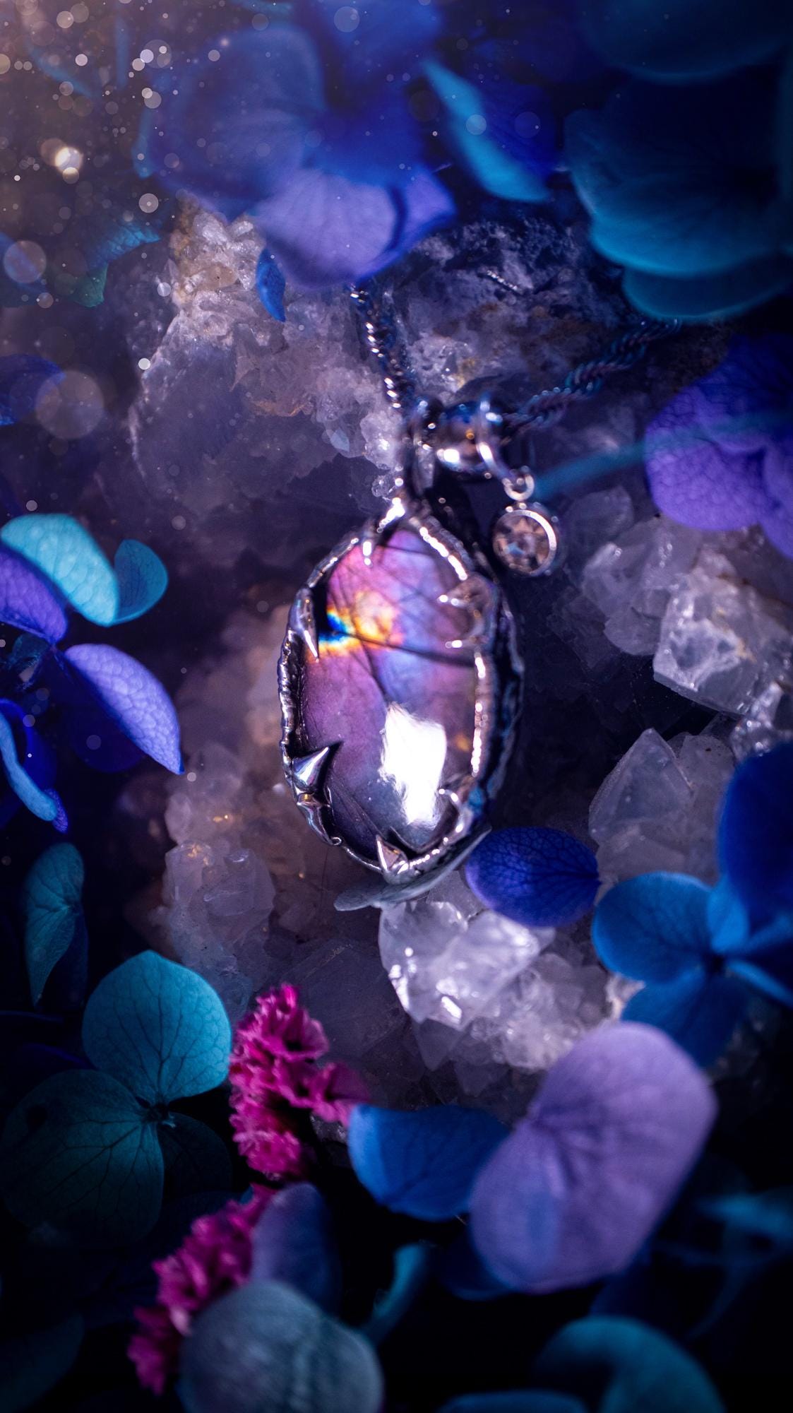 Beautifully handmade and bespoke, purple labradorite, soft soldered pendant necklace. This dainty labradorite pendant has been crafted using the soft solder method, also known as the tiffany technique. The crystal has a bezel of lead free soft solder which contains small parts of silver that allows for oxidisation and a high lustre polish. This labradorite is full of beautiful pinks, purples and has a lovely flash. One off, gothic and witchy jewellery with little claws on the bezel.