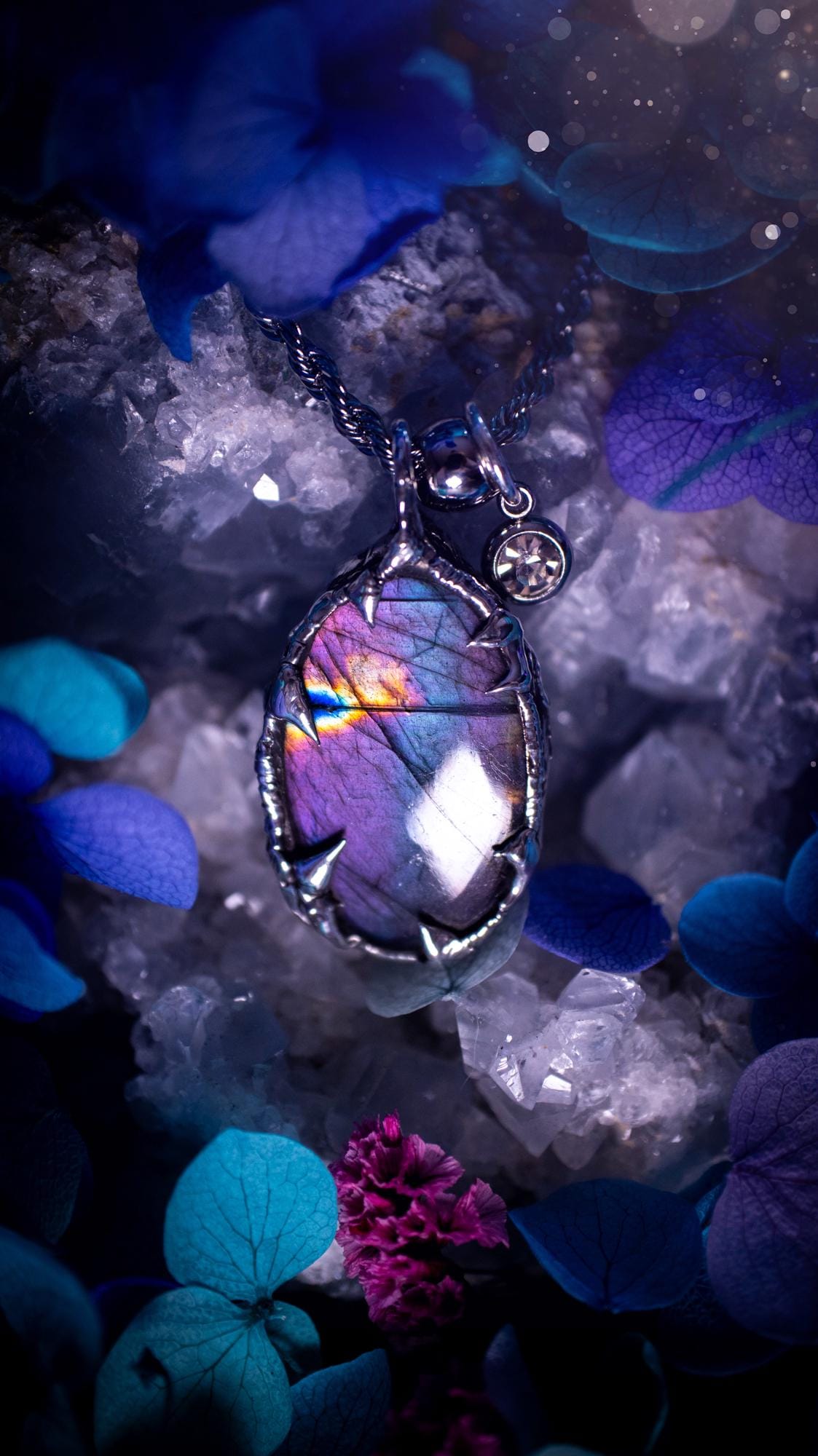 Beautifully handmade and bespoke, purple labradorite, soft soldered pendant necklace. This dainty labradorite pendant has been crafted using the soft solder method, also known as the tiffany technique. The crystal has a bezel of lead free soft solder which contains small parts of silver that allows for oxidisation and a high lustre polish. This labradorite is full of beautiful pinks, purples and has a lovely flash. One off, gothic and witchy jewellery with little claws on the bezel.