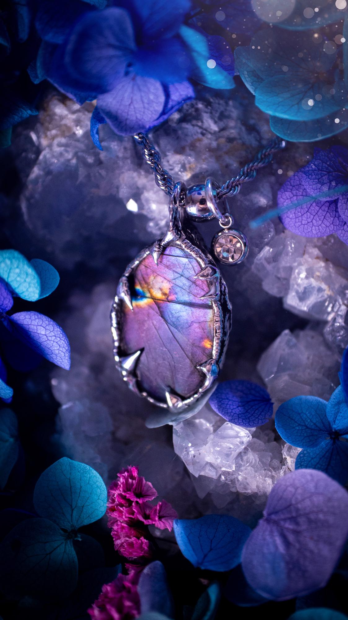 Beautifully handmade and bespoke, purple labradorite, soft soldered pendant necklace. This dainty labradorite pendant has been crafted using the soft solder method, also known as the tiffany technique. The crystal has a bezel of lead free soft solder which contains small parts of silver that allows for oxidisation and a high lustre polish. This labradorite is full of beautiful pinks, purples and has a lovely flash. One off, gothic and witchy jewellery with little claws on the bezel.