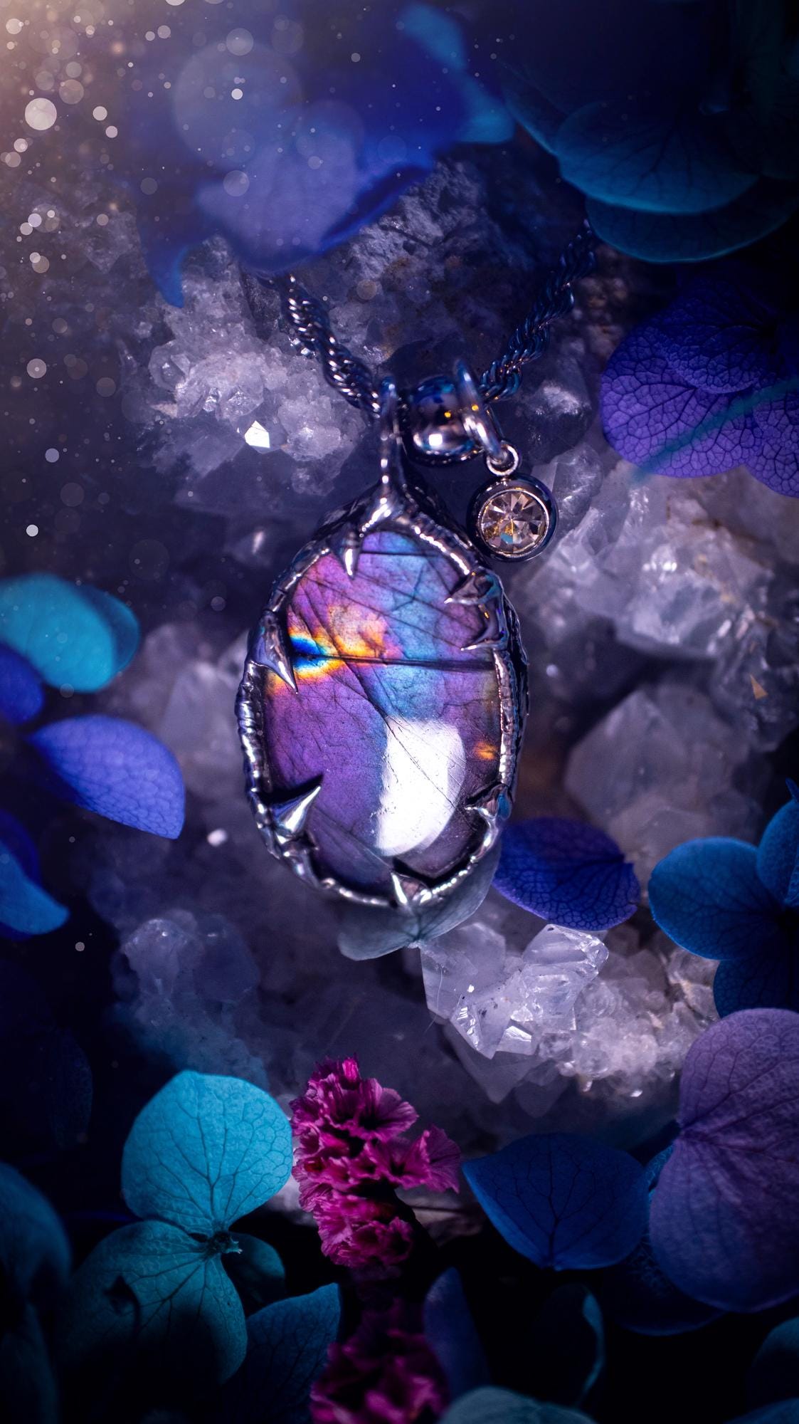 Beautifully handmade and bespoke, purple labradorite, soft soldered pendant necklace. This dainty labradorite pendant has been crafted using the soft solder method, also known as the tiffany technique. The crystal has a bezel of lead free soft solder which contains small parts of silver that allows for oxidisation and a high lustre polish. This labradorite is full of beautiful pinks, purples and has a lovely flash. One off, gothic and witchy jewellery with little claws on the bezel.