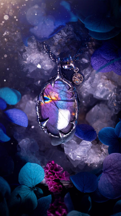 Beautifully handmade and bespoke, purple labradorite, soft soldered pendant necklace. This dainty labradorite pendant has been crafted using the soft solder method, also known as the tiffany technique. The crystal has a bezel of lead free soft solder which contains small parts of silver that allows for oxidisation and a high lustre polish. This labradorite is full of beautiful pinks, purples and has a lovely flash. One off, gothic and witchy jewellery with little claws on the bezel.