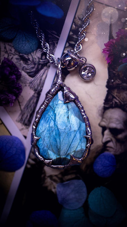 A stunning, and one off pendant necklace. Icy blue labradorite with a facet cut soft soldered pendant. This piece of jewellery has been handmade and features a very high quality, icy blue, natural labradorite crystal. Made using the soft solder method with lead free solder that contains mixed metals including silver. The piece is then polished to a high lustre. Featuring little claws for that gothic and witchy look. Ideal for any crystal and jewellery lover who would like a one of a kind piece.