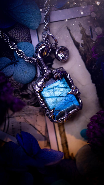 A stunning, and one off pendant necklace. Icy blue labradorite with a facet cut soft soldered pendant. This piece of jewellery has been handmade and features a very high quality, icy blue, natural labradorite crystal. Made using the soft solder method with lead free solder that contains mixed metals including silver. The piece is then polished to a high lustre. Featuring little claws for that gothic and witchy look. Ideal for any crystal and jewellery lover who would like a one of a kind piece.