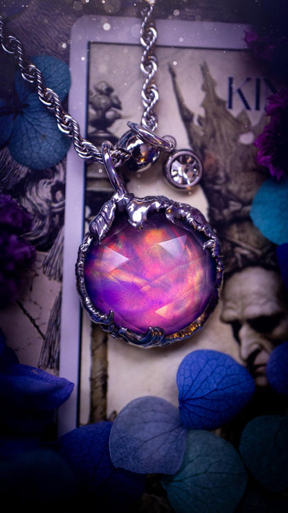 A beautiful, one of a kind, aurora opal pendant necklace. This little statement necklace is handmade using the tiffany technique, also known as soft soldering. Featuring the most stunning, and sparkly aurora opal which is full of pinks, greens and blues just like the northern lights. Aurora opals are man made opals that look similar to natural ones, they have a layer of rose quartz on top to give extra shine. The ideal gift for any crystal or jewellery lover. Gothic and witchy jewellery