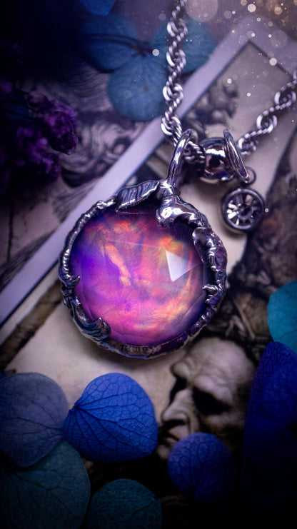 A beautiful, one of a kind, aurora opal pendant necklace. This little statement necklace is handmade using the tiffany technique, also known as soft soldering. Featuring the most stunning, and sparkly aurora opal which is full of pinks, greens and blues just like the northern lights. Aurora opals are man made opals that look similar to natural ones, they have a layer of rose quartz on top to give extra shine. The ideal gift for any crystal or jewellery lover. Gothic and witchy jewellery