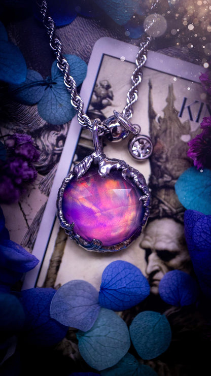 A beautiful, one of a kind, aurora opal pendant necklace. This little statement necklace is handmade using the tiffany technique, also known as soft soldering. Featuring the most stunning, and sparkly aurora opal which is full of pinks, greens and blues just like the northern lights. Aurora opals are man made opals that look similar to natural ones, they have a layer of rose quartz on top to give extra shine. The ideal gift for any crystal or jewellery lover. Gothic and witchy jewellery