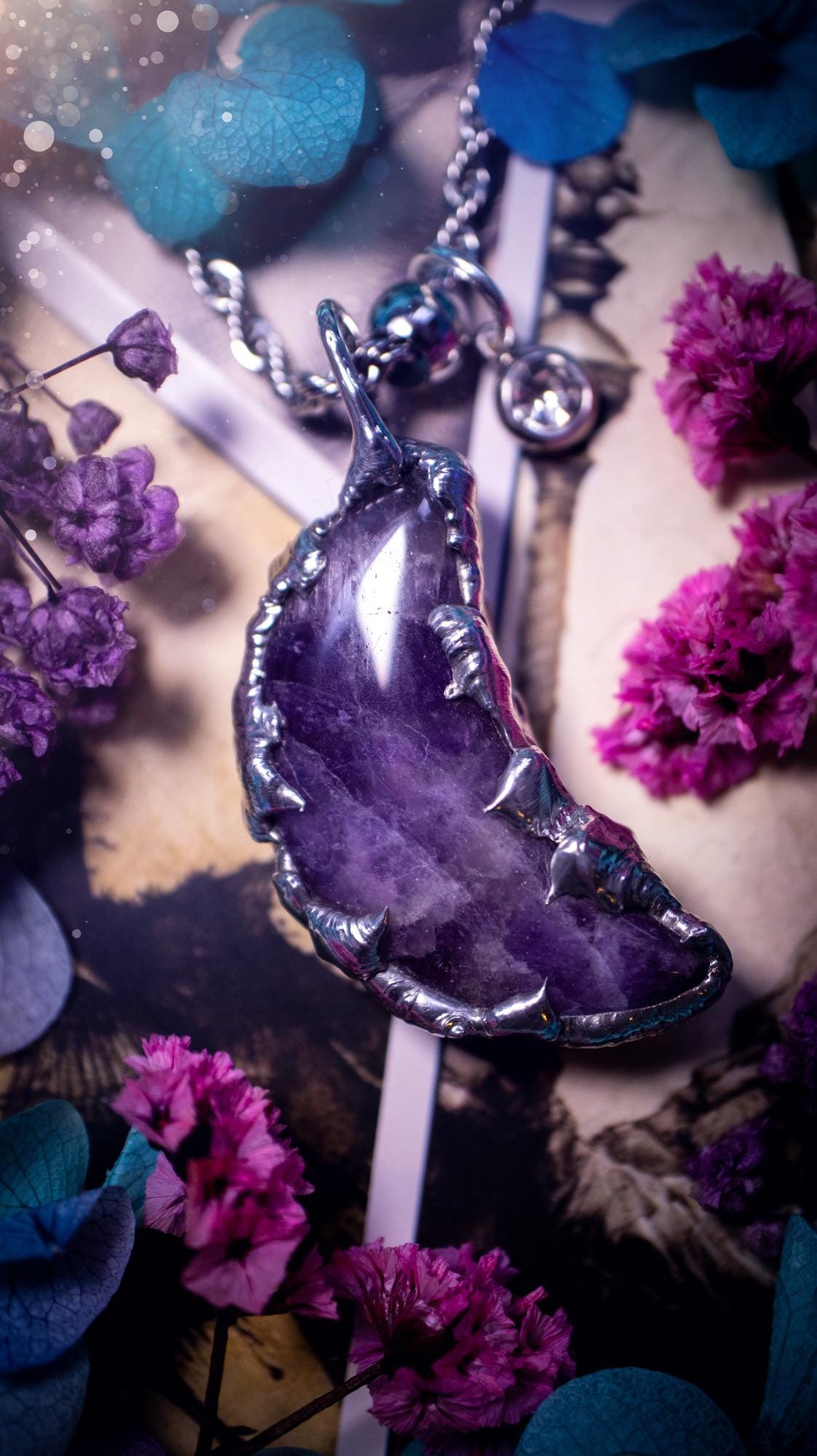 Beautifully bespoke and handcrafted, amethyst, soft soldered moon pendant necklace. This necklace has been handmade using the soft solder method with lead free solder with mix metals including silver. Featuring a gorgeous amethyst moon with stunning patterns. This piece is very unique and comes with its own little cubic zirconia charm. This pendant necklace would be suitable for anyone who loves crystals and jewellery, and that also loves a gothic and witchy vibe! Total soul jewellery