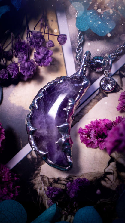 Beautifully bespoke and handcrafted, amethyst, soft soldered moon pendant necklace. This necklace has been handmade using the soft solder method with lead free solder with mix metals including silver. Featuring a gorgeous amethyst moon with stunning patterns. This piece is very unique and comes with its own little cubic zirconia charm. This pendant necklace would be suitable for anyone who loves crystals and jewellery, and that also loves a gothic and witchy vibe! Total soul jewellery