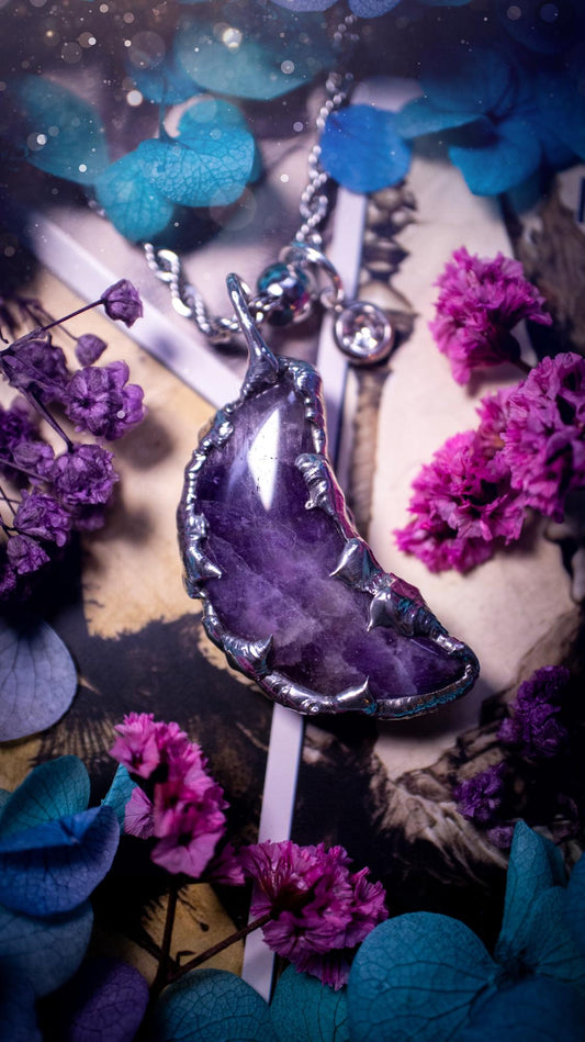 Beautifully bespoke and handcrafted, amethyst, soft soldered moon pendant necklace. This necklace has been handmade using the soft solder method with lead free solder with mix metals including silver. Featuring a gorgeous amethyst moon with stunning patterns. This piece is very unique and comes with its own little cubic zirconia charm. This pendant necklace would be suitable for anyone who loves crystals and jewellery, and that also loves a gothic and witchy vibe! Total soul jewellery