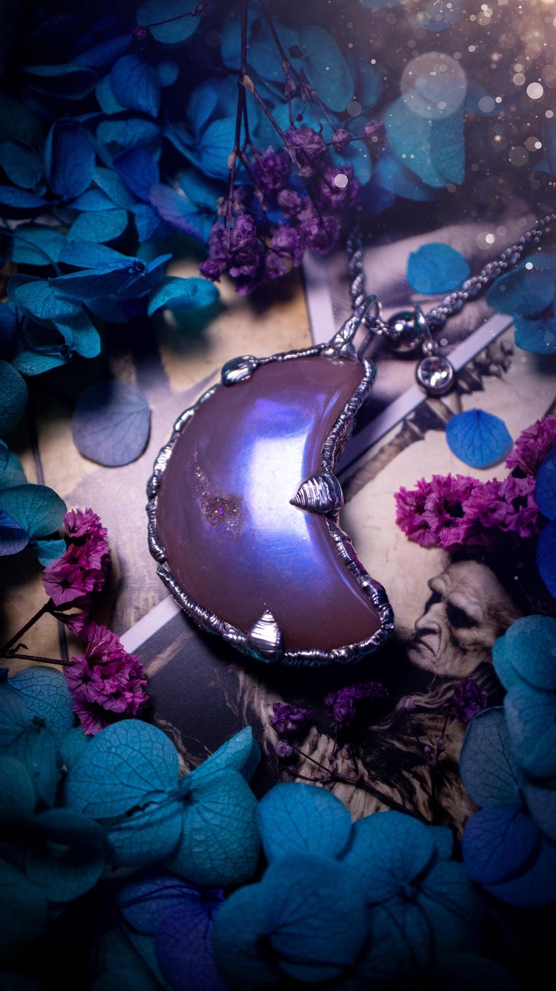 Beautifully bespoke, aurora coated agate, soft soldered moon pendant necklace. This necklace has been handmade using the soft solder method with lead free solder with mix metals including silver. Featuring a gorgeous aurora coated agate moon with a sparkly druzy pocket. This piece is very unique and comes with its own little cubic zirconia charm. This pendant necklace would be suitable for anyone who loves crystals and jewellery, and that also loves a gothic and witchy vibe! Total soul jewellery