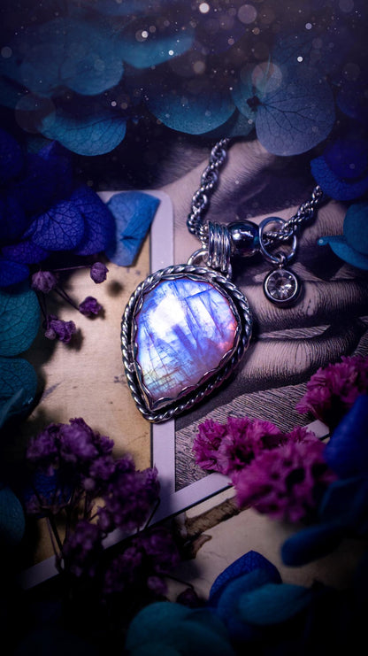 Handmade and bespoke, pink rainbow moonstone, sterling silver pendant necklace. This lovely pendant feature a very high quality rainbow moonstone that is full of gorgeous pink and blue flash. This unusual pink colour has been created by using materials under the stone so the pink hue shines through with the iridescence of the moonstone. Made from fine and sterling silver. An ideal piece for any crystal and jewellery lover. Moonstone is the birthstone for June. Unique gothic jewellery