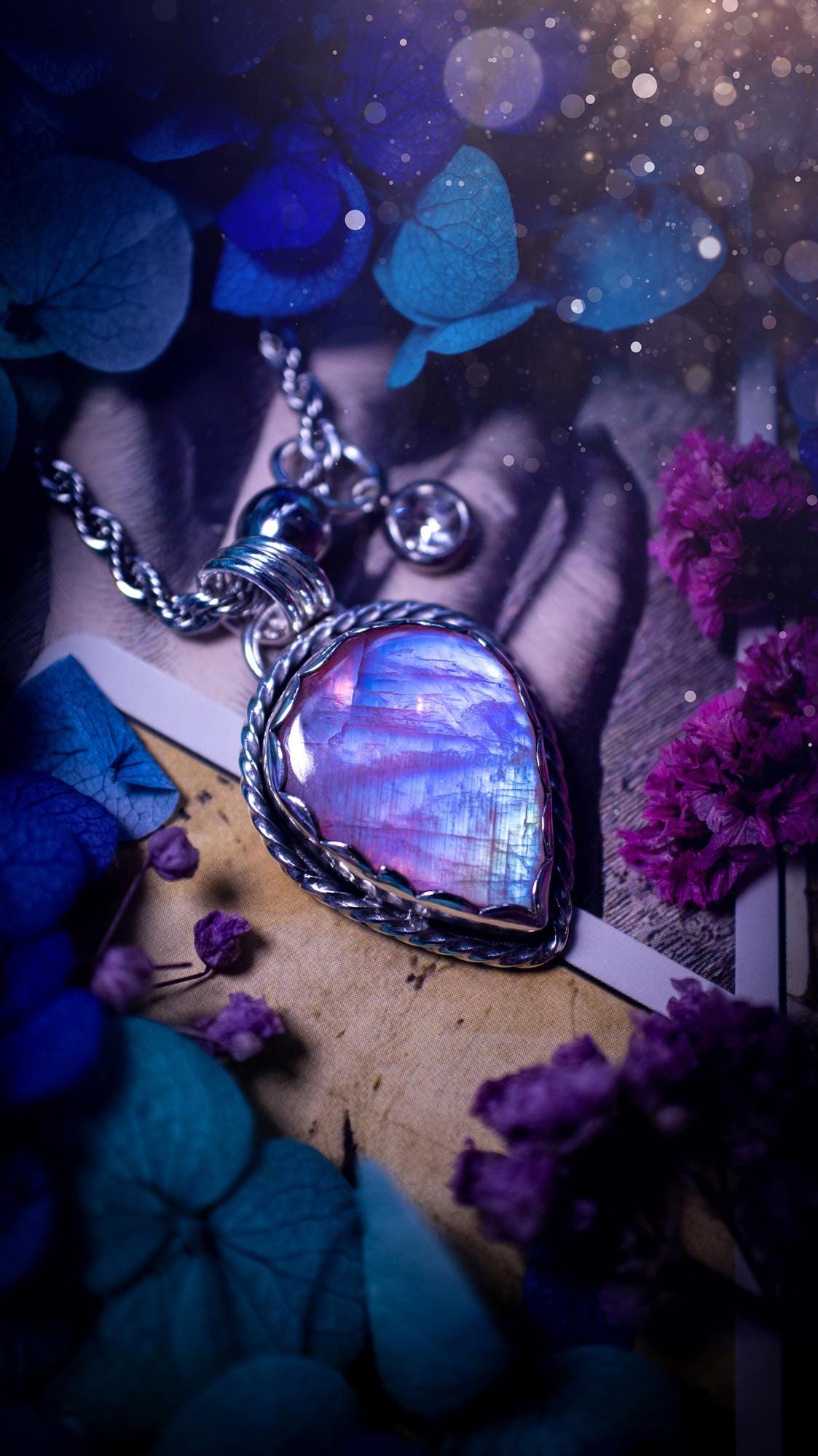 Handmade and bespoke, pink rainbow moonstone, sterling silver pendant necklace. This lovely pendant feature a very high quality rainbow moonstone that is full of gorgeous pink and blue flash. This unusual pink colour has been created by using materials under the stone so the pink hue shines through with the iridescence of the moonstone. Made from fine and sterling silver. An ideal piece for any crystal and jewellery lover. Moonstone is the birthstone for June. Unique gothic jewellery