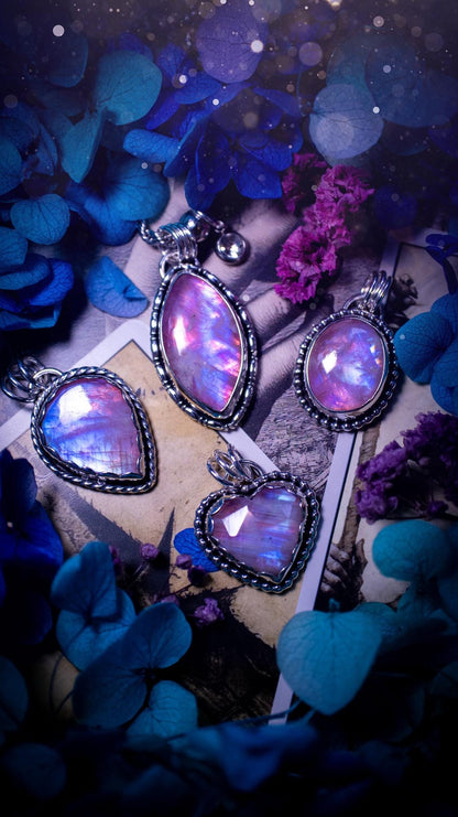 Handmade and bespoke, pink rainbow moonstone, sterling silver pendant necklace. This lovely pendant feature a very high quality rainbow moonstone that is full of gorgeous pink and blue flash. This unusual pink colour has been created by using materials under the stone so the pink hue shines through with the iridescence of the moonstone. Made from fine and sterling silver. An ideal piece for any crystal and jewellery lover. Moonstone is the birthstone for June. Unique gothic jewellery