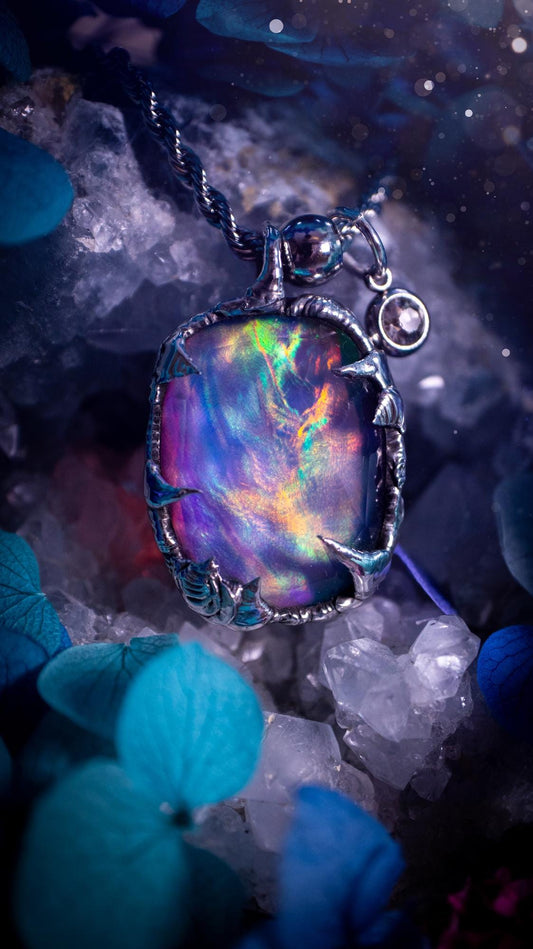 A beautiful, one of a kind, aurora opal pendant necklace. This little statement necklace is handmade using the tiffany technique, also known as soft soldering. Featuring the most stunning, and sparkly aurora opal which is full of pinks, greens and blues just like the northern lights. Aurora opals are man made opals that look similar to natural ones, they have a layer of rose quartz on top to give extra shine. The ideal gift for any crystal or jewellery lover. Gothic and witchy jewellery