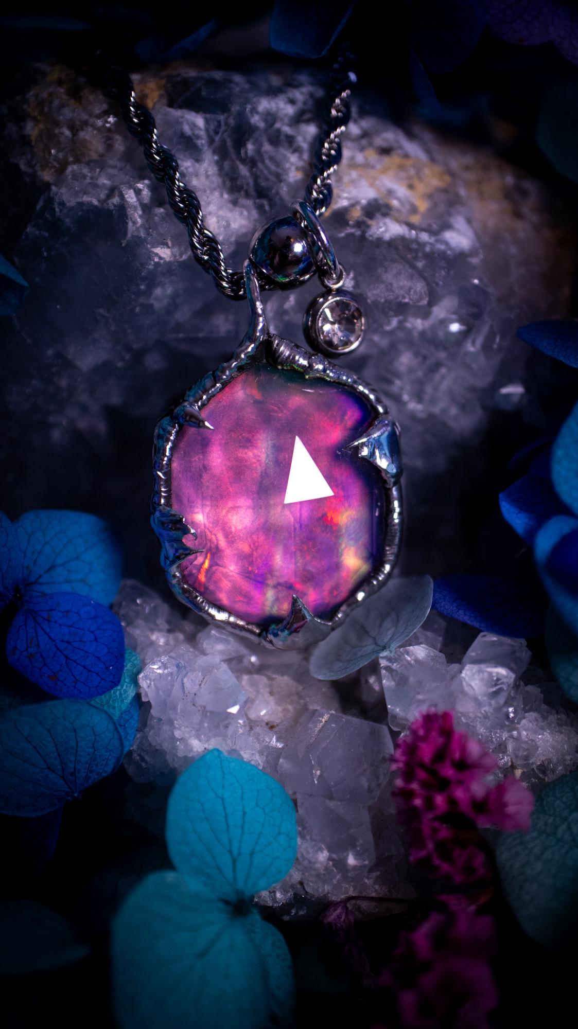 A beautiful, one of a kind, aurora opal pendant necklace. This little statement necklace is handmade using the tiffany technique, also known as soft soldering. Featuring the most stunning, and sparkly aurora opal which is full of pinks, greens and blues just like the northern lights. Aurora opals are man made opals that look similar to natural ones, they have a layer of rose quartz on top to give extra shine. The ideal gift for any crystal or jewellery lover. Gothic and witchy jewellery