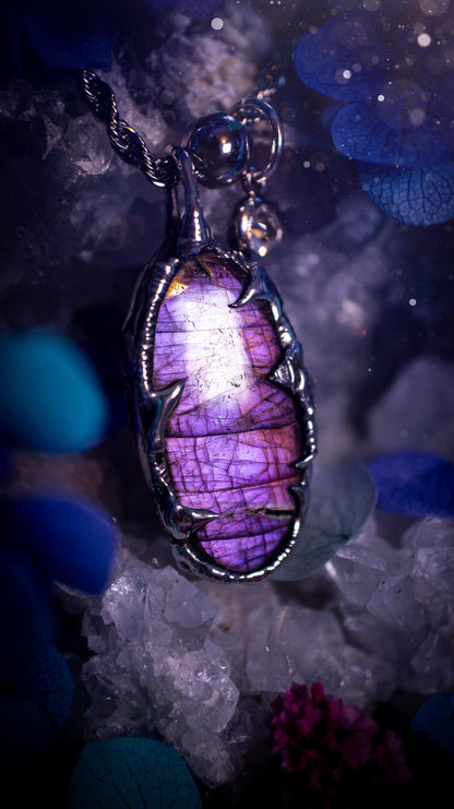 Beautifully handmade and bespoke, purple labradorite, soft soldered pendant necklace. This dainty labradorite pendant has been crafted using the soft solder method, also known as the tiffany technique. The crystal has a bezel of lead free soft solder which contains small parts of silver that allows for oxidisation and a high lustre polish. This labradorite is full of beautiful pinks, purples and has a lovely flash. One off, gothic and witchy jewellery with little claws on the bezel.