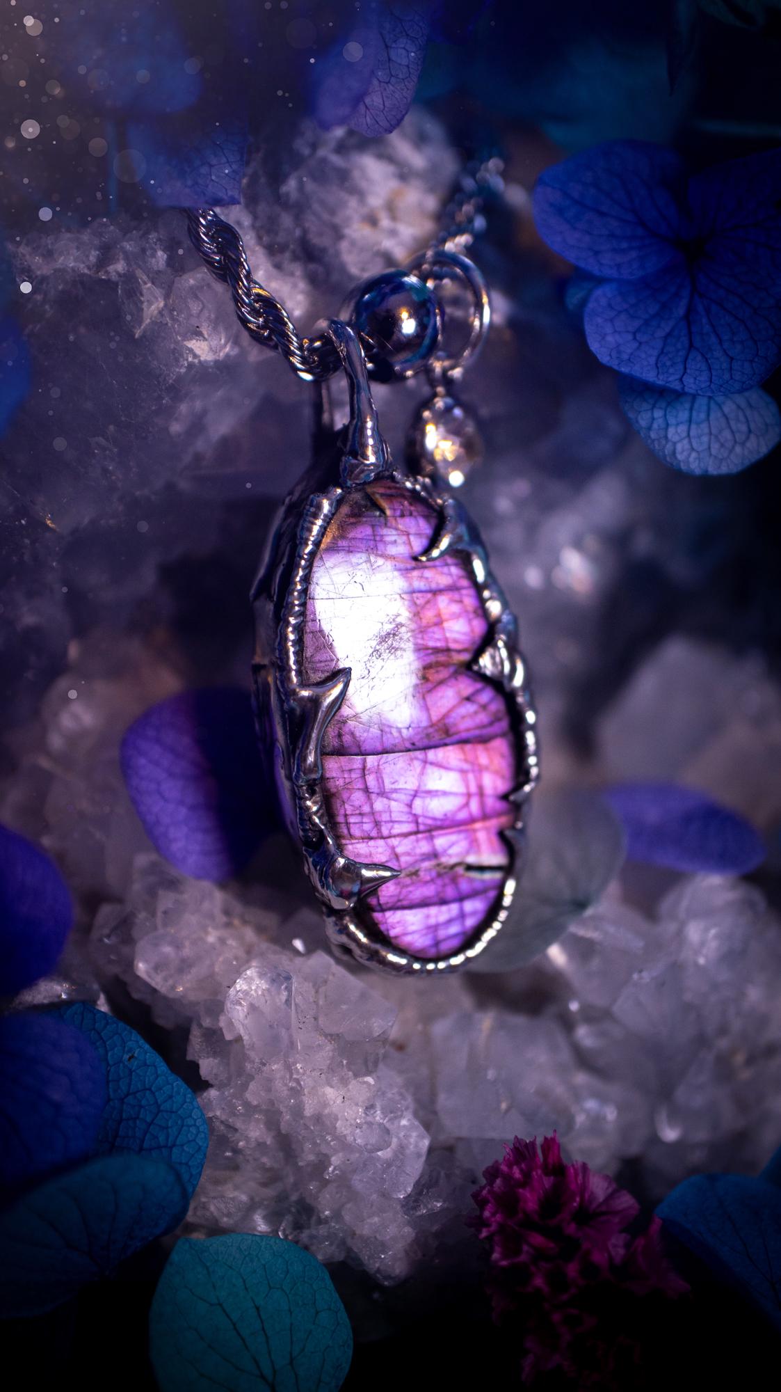 Beautifully handmade and bespoke, purple labradorite, soft soldered pendant necklace. This dainty labradorite pendant has been crafted using the soft solder method, also known as the tiffany technique. The crystal has a bezel of lead free soft solder which contains small parts of silver that allows for oxidisation and a high lustre polish. This labradorite is full of beautiful pinks, purples and has a lovely flash. One off, gothic and witchy jewellery with little claws on the bezel.