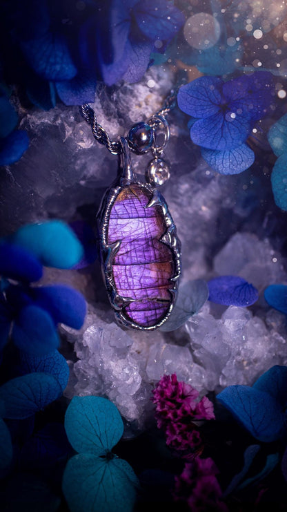 Beautifully handmade and bespoke, purple labradorite, soft soldered pendant necklace. This dainty labradorite pendant has been crafted using the soft solder method, also known as the tiffany technique. The crystal has a bezel of lead free soft solder which contains small parts of silver that allows for oxidisation and a high lustre polish. This labradorite is full of beautiful pinks, purples and has a lovely flash. One off, gothic and witchy jewellery with little claws on the bezel.