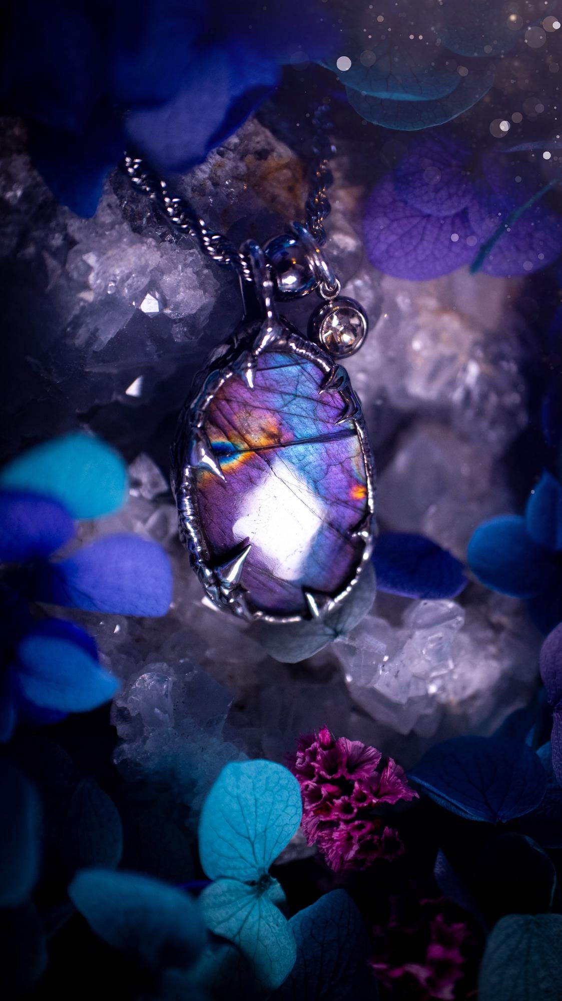 Beautifully handmade and bespoke, purple labradorite, soft soldered pendant necklace. This dainty labradorite pendant has been crafted using the soft solder method, also known as the tiffany technique. The crystal has a bezel of lead free soft solder which contains small parts of silver that allows for oxidisation and a high lustre polish. This labradorite is full of beautiful pinks, purples and has a lovely flash. One off, gothic and witchy jewellery with little claws on the bezel.