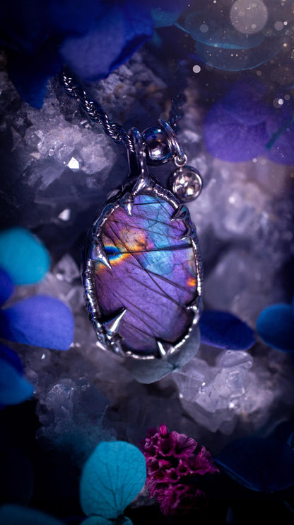 Beautifully handmade and bespoke, purple labradorite, soft soldered pendant necklace. This dainty labradorite pendant has been crafted using the soft solder method, also known as the tiffany technique. The crystal has a bezel of lead free soft solder which contains small parts of silver that allows for oxidisation and a high lustre polish. This labradorite is full of beautiful pinks, purples and has a lovely flash. One off, gothic and witchy jewellery with little claws on the bezel.