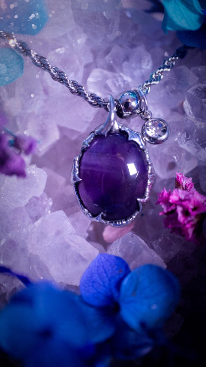 Handmade and dainty, amethyst crystal, soft soldered pendant necklace. This pendant necklace is one of a kind, with a beautiful amethyst crystal with a gorgeous hue of purple. Hand crafted using the soft solder method using lead free solder that contains small amounts of silver. Little claws feature around the amethyst, giving it a gothic and witchy vibe. This pendant will be ideal for any crystal or jewellery lover that is looking for a bespoke, unique piece.