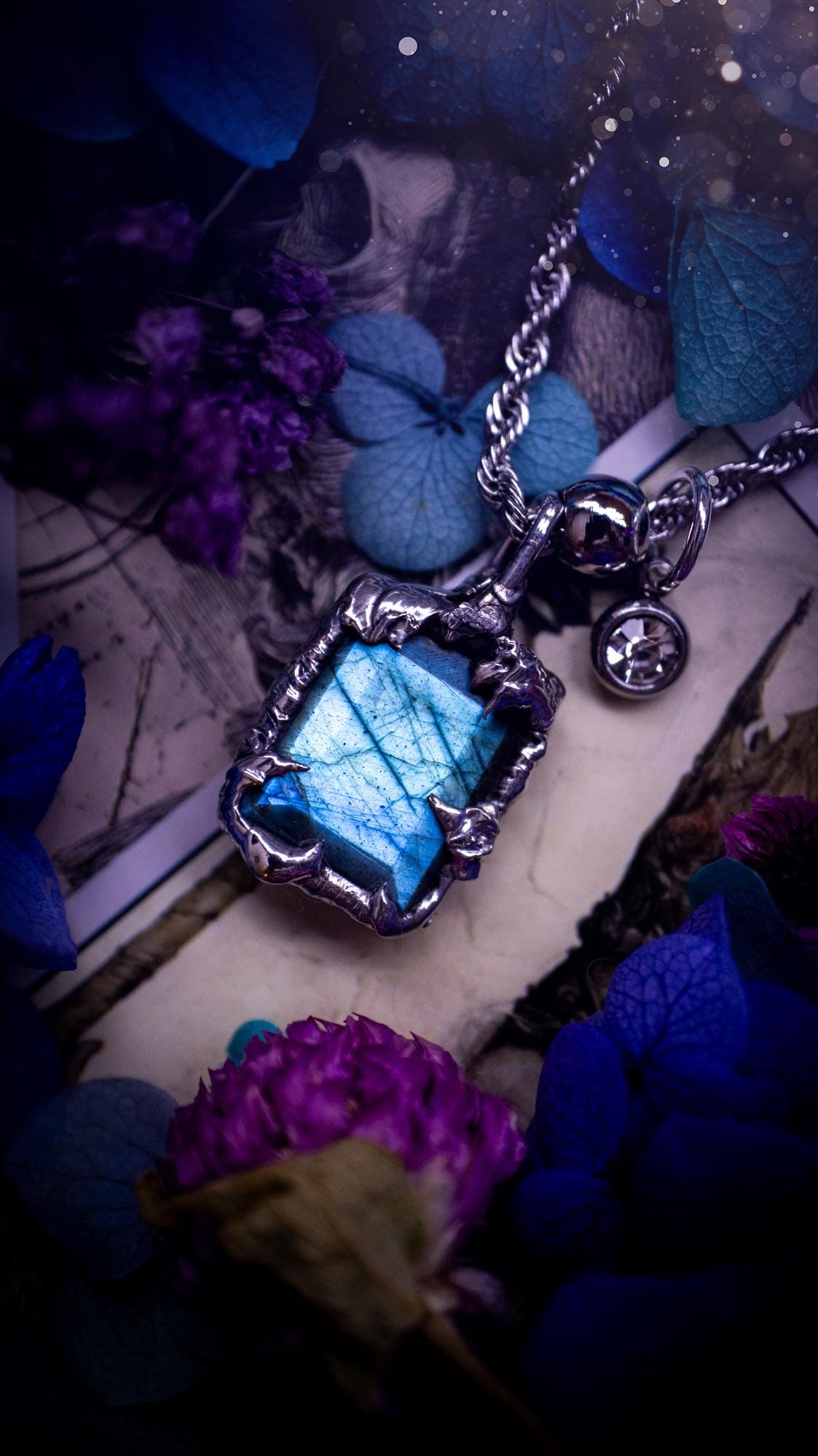 A stunning, and one off pendant necklace. Icy blue labradorite with a facet cut soft soldered pendant. This piece of jewellery has been handmade and features a very high quality, icy blue, natural labradorite crystal. Made using the soft solder method with lead free solder that contains mixed metals including silver. The piece is then polished to a high lustre. Featuring little claws for that gothic and witchy look. Ideal for any crystal and jewellery lover who would like a one of a kind piece.