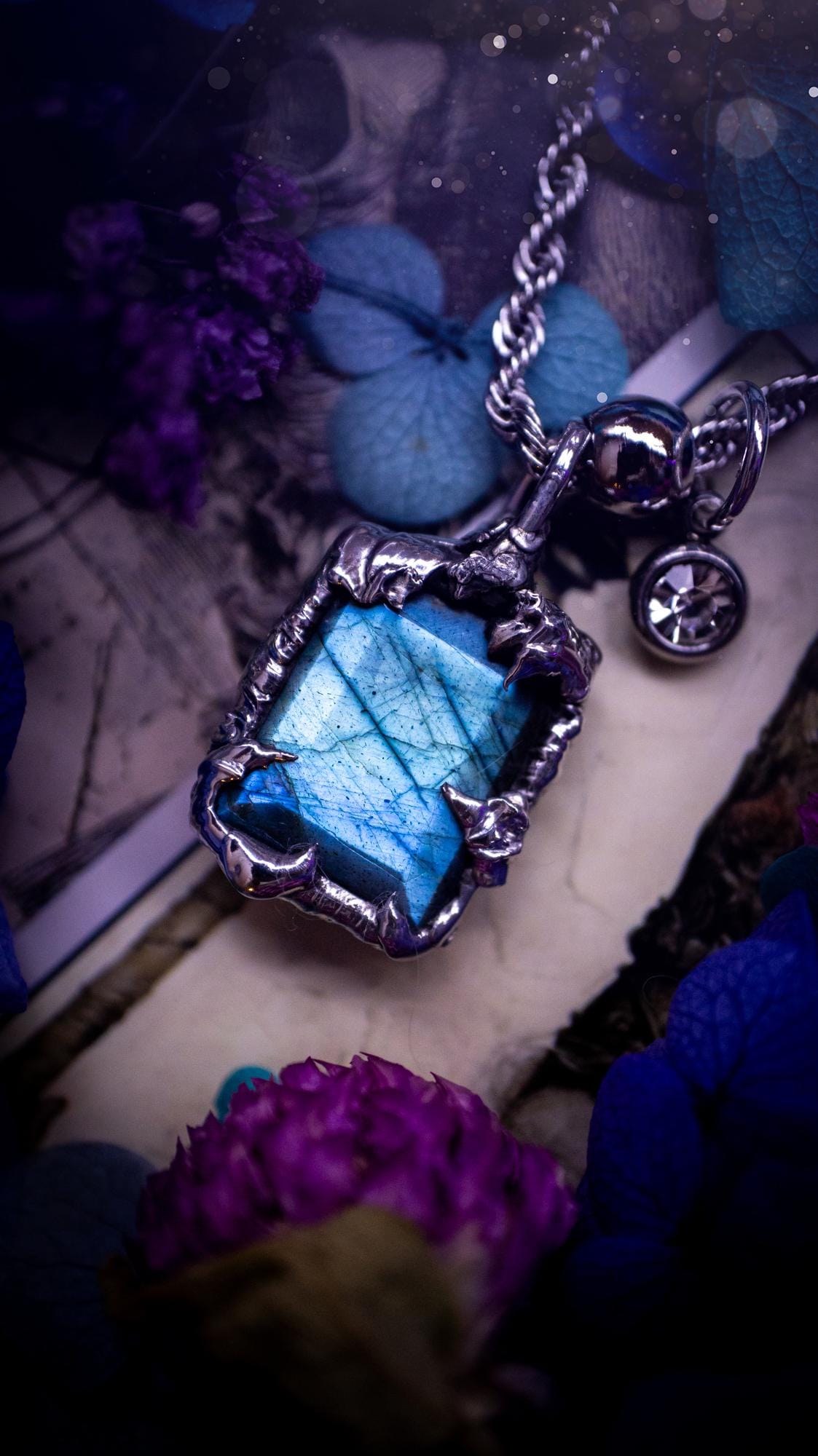 A stunning, and one off pendant necklace. Icy blue labradorite with a facet cut soft soldered pendant. This piece of jewellery has been handmade and features a very high quality, icy blue, natural labradorite crystal. Made using the soft solder method with lead free solder that contains mixed metals including silver. The piece is then polished to a high lustre. Featuring little claws for that gothic and witchy look. Ideal for any crystal and jewellery lover who would like a one of a kind piece.