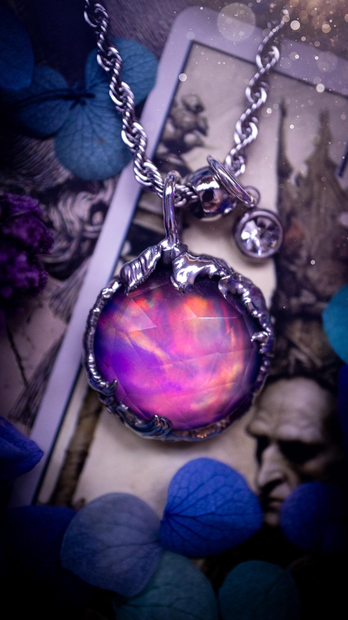 A beautiful, one of a kind, aurora opal pendant necklace. This little statement necklace is handmade using the tiffany technique, also known as soft soldering. Featuring the most stunning, and sparkly aurora opal which is full of pinks, greens and blues just like the northern lights. Aurora opals are man made opals that look similar to natural ones, they have a layer of rose quartz on top to give extra shine. The ideal gift for any crystal or jewellery lover. Gothic and witchy jewellery