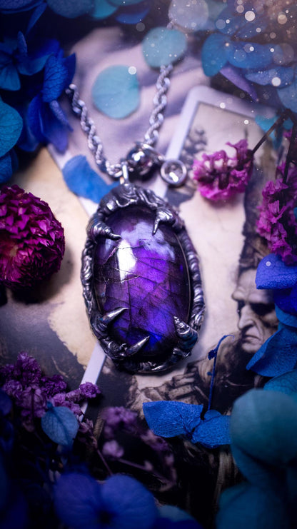 Beautiful and handmade, totally bespoke, purple labradorite pendant necklace. This necklace has been created using the soft solder method with lead free solder for a rustic and gothic look. Featuring a stunning and natural purple blue labradorite crystal. This pendant resembles what I would describe a dragon egg that is being held by the claws off a dragon! Very unique and one off. This piece would make an ideal gift for any crystal or jewellery fan that is into a gothic and witchy vibe!