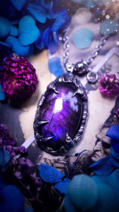 Beautiful and handmade, totally bespoke, purple labradorite pendant necklace. This necklace has been created using the soft solder method with lead free solder for a rustic and gothic look. Featuring a stunning and natural purple blue labradorite crystal. This pendant resembles what I would describe a dragon egg that is being held by the claws off a dragon! Very unique and one off. This piece would make an ideal gift for any crystal or jewellery fan that is into a gothic and witchy vibe!