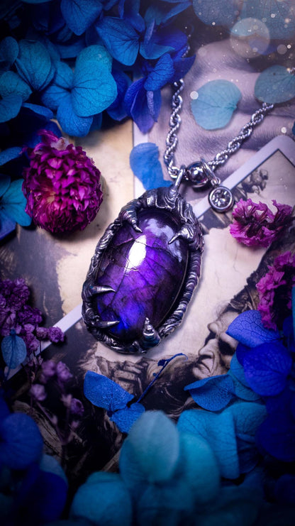 Beautiful and handmade, totally bespoke, purple labradorite pendant necklace. This necklace has been created using the soft solder method with lead free solder for a rustic and gothic look. Featuring a stunning and natural purple blue labradorite crystal. This pendant resembles what I would describe a dragon egg that is being held by the claws off a dragon! Very unique and one off. This piece would make an ideal gift for any crystal or jewellery fan that is into a gothic and witchy vibe!