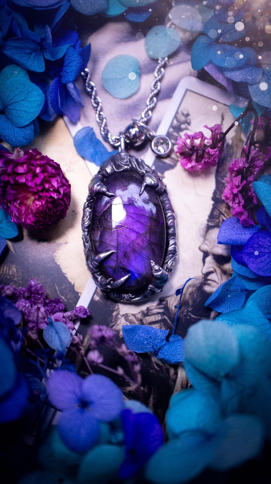 Beautiful and handmade, totally bespoke, purple labradorite pendant necklace. This necklace has been created using the soft solder method with lead free solder for a rustic and gothic look. Featuring a stunning and natural purple blue labradorite crystal. This pendant resembles what I would describe a dragon egg that is being held by the claws off a dragon! Very unique and one off. This piece would make an ideal gift for any crystal or jewellery fan that is into a gothic and witchy vibe!