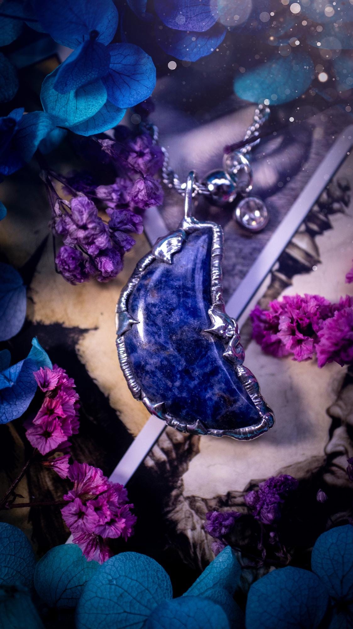 Beautifully bespoke and handcrafted, sodalite, soft soldered moon pendant necklace. This necklace has been handmade using the soft solder method with lead free solder with mix metals including silver. Featuring a gorgeous sodalite moon with stunning patterns. This piece is very unique and comes with its own little cubic zirconia charm. This pendant necklace would be suitable for anyone who loves crystals and jewellery, and that also loves a gothic and witchy vibe! Total soul jewellery