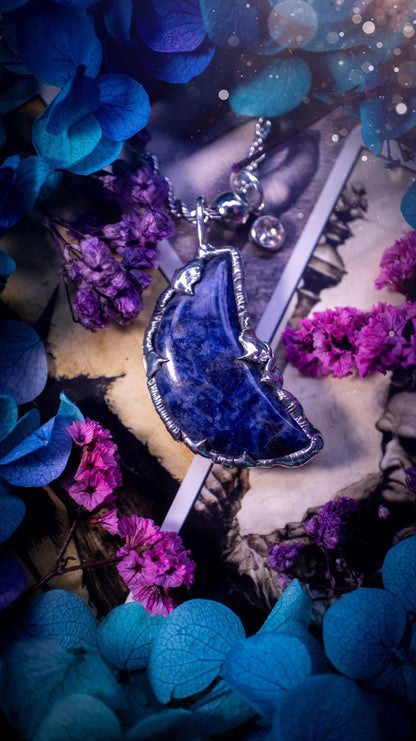 Beautifully bespoke and handcrafted, sodalite, soft soldered moon pendant necklace. This necklace has been handmade using the soft solder method with lead free solder with mix metals including silver. Featuring a gorgeous sodalite moon with stunning patterns. This piece is very unique and comes with its own little cubic zirconia charm. This pendant necklace would be suitable for anyone who loves crystals and jewellery, and that also loves a gothic and witchy vibe! Total soul jewellery