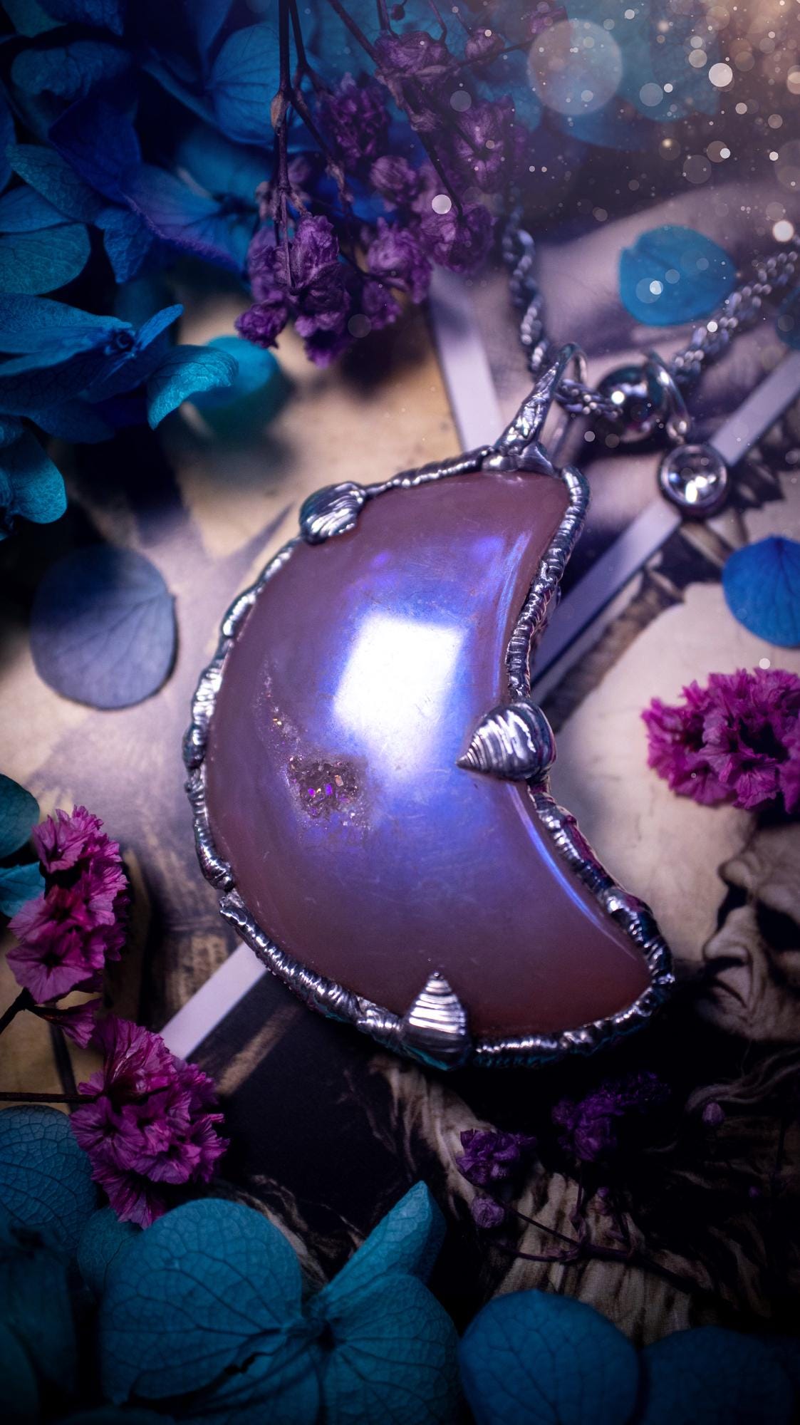 Beautifully bespoke, aurora coated agate, soft soldered moon pendant necklace. This necklace has been handmade using the soft solder method with lead free solder with mix metals including silver. Featuring a gorgeous aurora coated agate moon with a sparkly druzy pocket. This piece is very unique and comes with its own little cubic zirconia charm. This pendant necklace would be suitable for anyone who loves crystals and jewellery, and that also loves a gothic and witchy vibe! Total soul jewellery