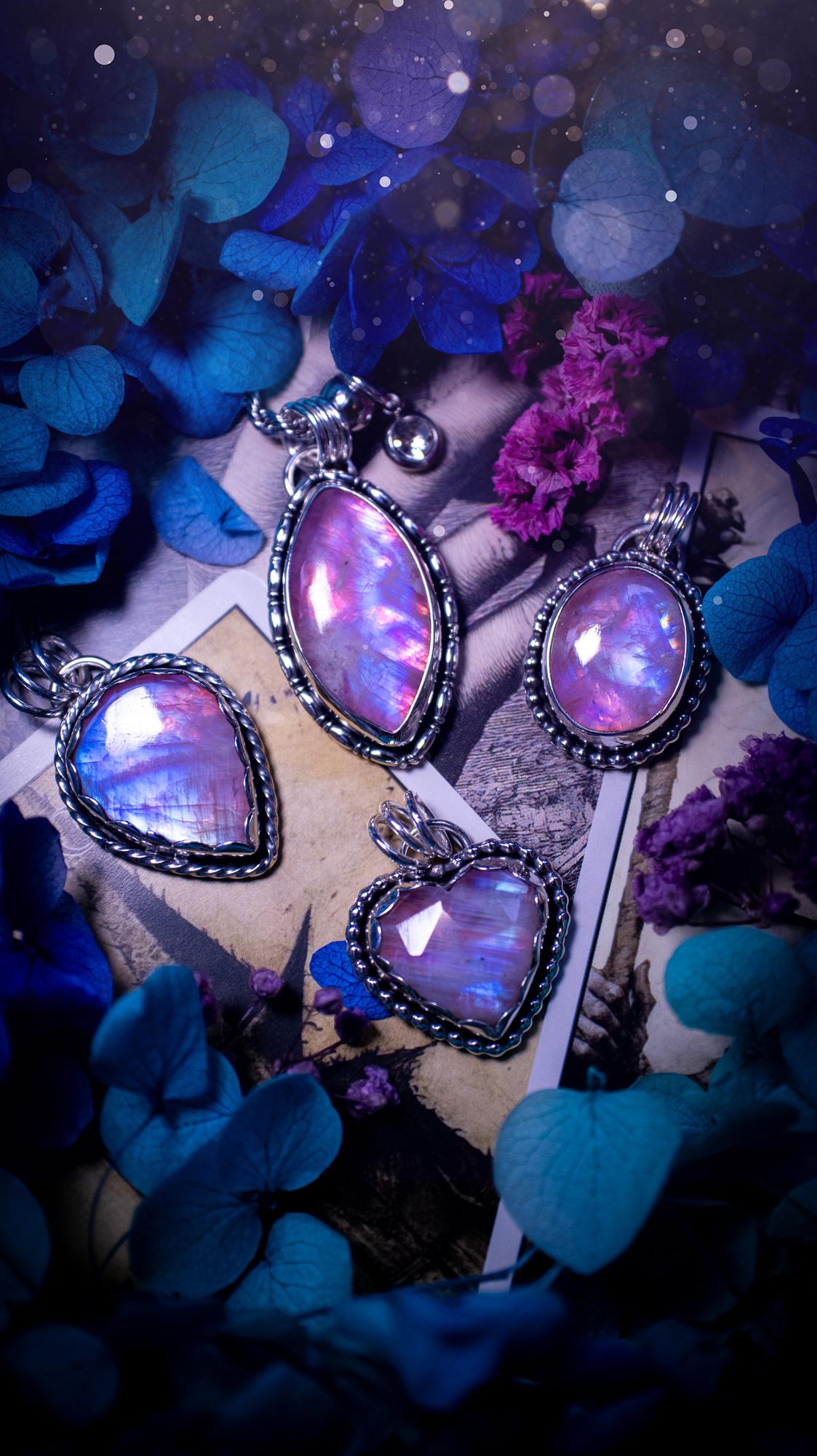 Handmade and bespoke, pink rainbow moonstone heart, sterling silver pendant necklace. This lovely pendant feature a very high quality rainbow moonstone that is full of gorgeous pink and blue flash. This unusual pink colour has been created by using materials under the stone so the pink hue shines through with the iridescence of the moonstone. Made from fine and sterling silver. An ideal piece for any crystal and jewellery lover. Moonstone is the birthstone for June. Unique gothic jewellery