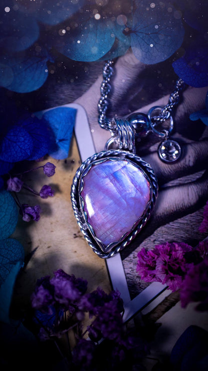Handmade and bespoke, pink rainbow moonstone, sterling silver pendant necklace. This lovely pendant feature a very high quality rainbow moonstone that is full of gorgeous pink and blue flash. This unusual pink colour has been created by using materials under the stone so the pink hue shines through with the iridescence of the moonstone. Made from fine and sterling silver. An ideal piece for any crystal and jewellery lover. Moonstone is the birthstone for June. Unique gothic jewellery